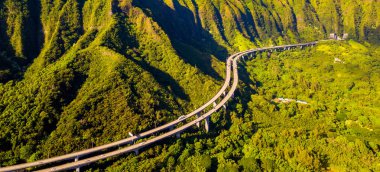 Gorgeous aerial view of the Oahu green mountains view by the Ho'omaluhia Botanical Garden in Kaneohe. Mountains with famous stairs to heaven or Haiku stairs. clipart