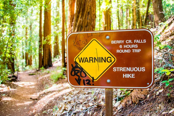 Berry Cr. Falls 6 hours round trip warning sign in a Red Wood National Park. Round trip will take you approximately six hours. Strenuous hike.