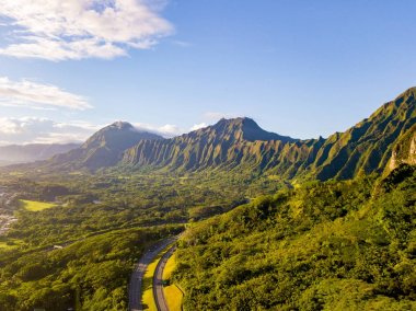 Gorgeous aerial view of the Oahu green mountains view by the Ho'omaluhia Botanical Garden in Kaneohe. Mountains with famous stairs to heaven or Haiku stairs.  clipart