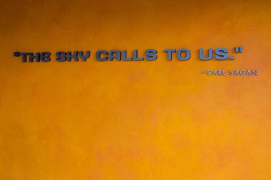 The sky calls to us. Carl Sagan. A title at the Kennedy Space center in Orlando.