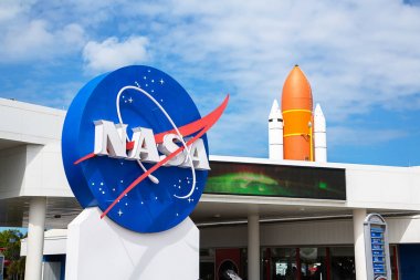 Orlando, Florida/USA - April 10 2013: Kennedy space center museum NASA sign with a rocket on the background clipart