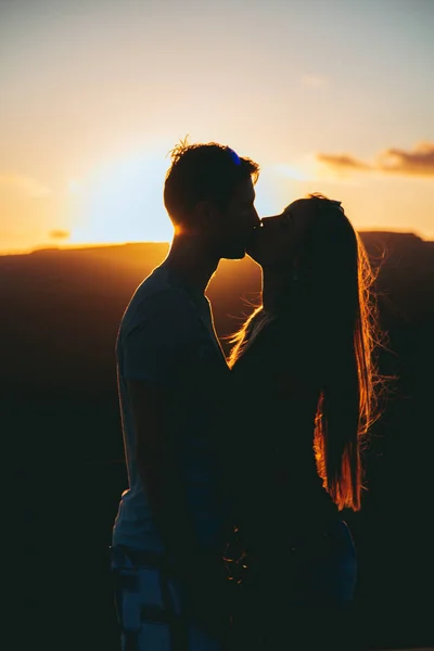 Beautiful couple kissing during sunset