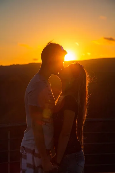 Hermosa pareja besándose durante el atardecer — Foto de Stock