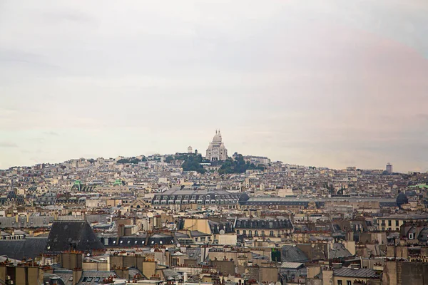 Aerial street view of Paris from above with the Montmartre church in the middle.