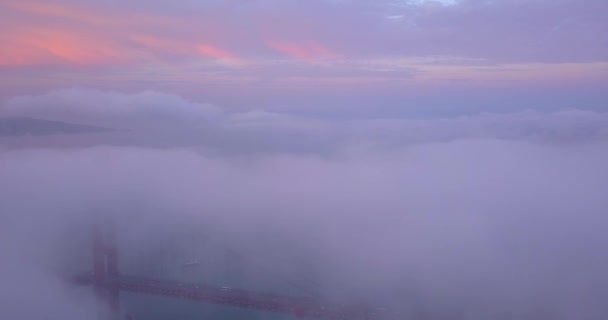 サンフランシスコのゴールデン ゲート ブリッジ 雲の上の夕焼け空中眺め 橋の上を飛んで雲とロマンチックなパノラマ ビュー — ストック動画