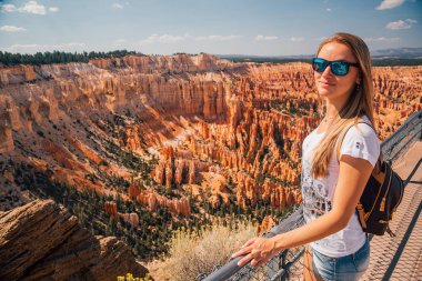 Young girl exploring Bryce Canyon. Hiking down the orange cliffs. Beautiful nature. clipart