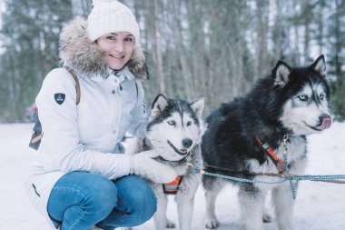 Sevimli kız ormanın içinde birçok dış yapraklar ile kış aylarında oynarken.