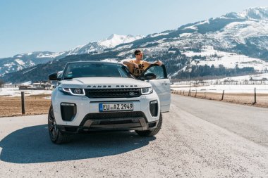 Avusturya, Alpler - 25 Mart 2018: Yeni beyaz 2018 Range Rover Evoque son markaya genç adam. Güzel araba Suv doğada Alpleri'nde derin. Yeni Suv Range Rover Evoque test.