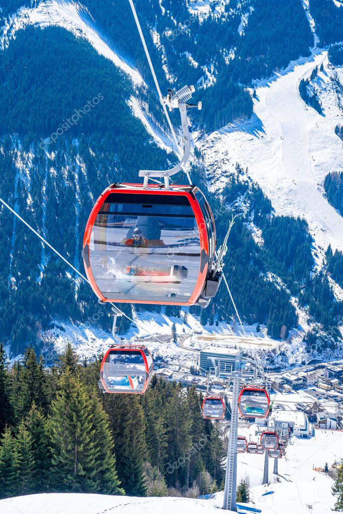 Davos, Switzerland. January 10, 2019. Mountain ski lift with seats going over the mountain and paths from skies and snowboards