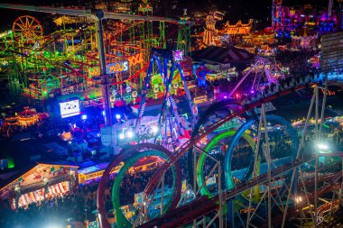 London, UK. December 2, 2019. London Wonderland. Night view of people walking in the Hyde Park's winter Wonder Land between different rides and attractions. Beautiful Christmas spirit in London.