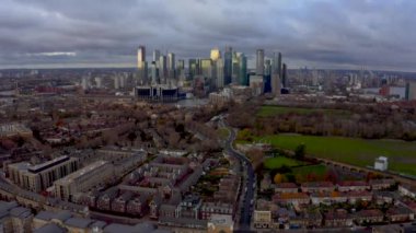 Aerial Panoramic skyline view of Bank and Canary Wharf, central London's leading financial districts with famous skyscrapers at golden hour sunset during cloudy skies. London, England