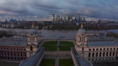 Aerial panoramic view of the National Maritime Museum in Greenwich, England with a Canary Wharf in the background. Beautiful London at sunset.