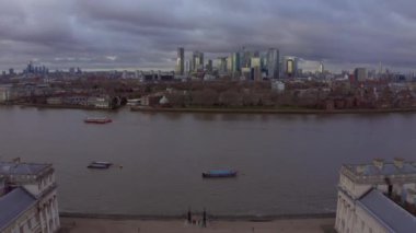 Aerial panoramic view of the National Maritime Museum in Greenwich, England with a Canary Wharf in the background. Beautiful London at sunset.