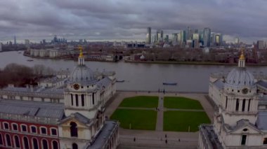 Aerial panoramic view of the National Maritime Museum in Greenwich, England with a Canary Wharf in the background. Beautiful London at sunset.