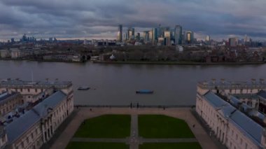 Aerial panoramic view of the National Maritime Museum in Greenwich, England with a Canary Wharf in the background. Beautiful London at sunset.