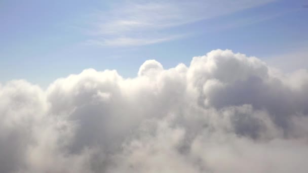 上の澄んだ青空と下の白い雲と雲の中を飛んでいます 美しい雲の背景シーン — ストック動画