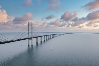Kopenhag Danimarka ile Malmö İsveç arasındaki Öresund köprüsü gün batımında deniz üzerinde.