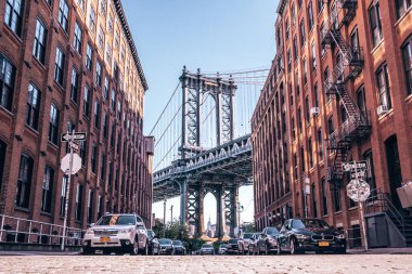 View of the Manhattan bridge from the narrow Washington street, Brooklyn, New York, USA  clipart