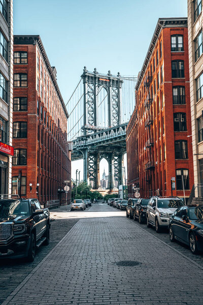 View of the Manhattan bridge from the narrow Washington street, Brooklyn, New York, USA