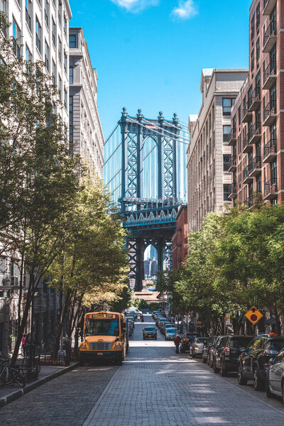 New York, USA. May 10, 2019. Terrific view of the Manhattan bridge from the narrow street of Brooklyn.