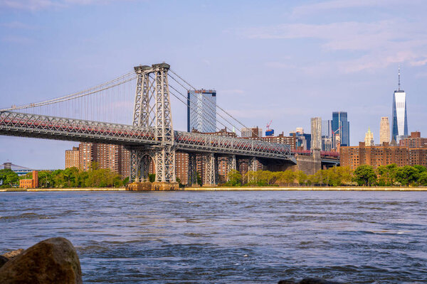 Panoramic view of the Williamsburg Bridge seen from Domino park in Brooklyn, New York.