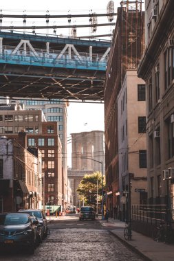 Brooklyn Köprüsü 'nün Brooklyn' deki Manhattan Köprüsü 'nün altından akşam güneşi manzarası.