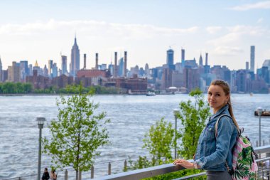 Sexy girl exploring Domino park sign in Williamsburg, New York. clipart