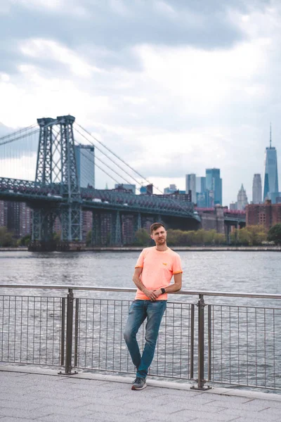 Young man exploring Domino park sign in Williamsburg, New York.