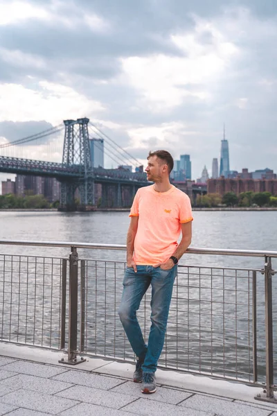 Young man exploring Domino park sign in Williamsburg, New York.