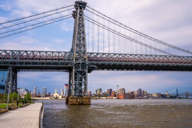 Panoramic view of the Williamsburg Bridge seen from Domino park in Brooklyn, New York. clipart