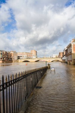 YORK, YORKSHIRE, UK - FEBRUARY 22, 2020.  A landscape view of the flooded streets of York after the River Ouse burst its banks causing excessive insurance damage to retail and property clipart