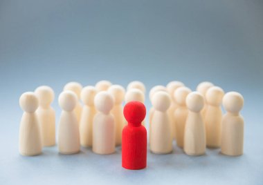 A concept image of a person standing out from a crowd as a leader or inspirational teacher amongst men and women clipart