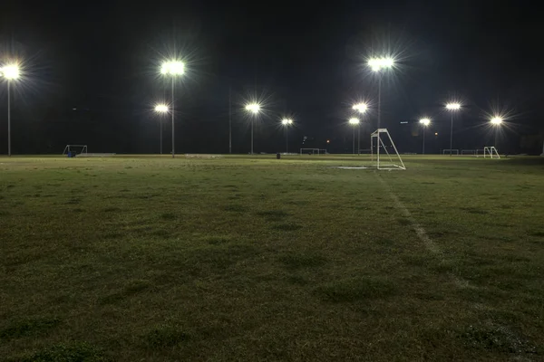 Campos de fútbol atléticos vacíos por la noche con luces encendidas —  Fotos de Stock