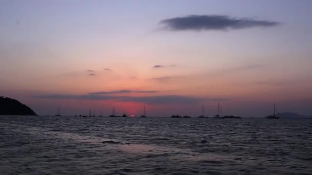Парусные лодки на фоне прекрасного заката — стоковое видео