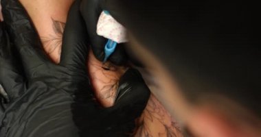 Dövmeci kadın eline makineli tüfek boyasıyla dövme yapmış..