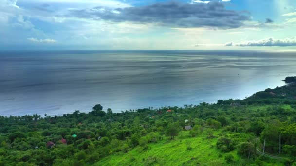 Yeşil dağların ve okyanus manzarasının üstündeki hava manzarası. Bali, Endonezya. — Stok video