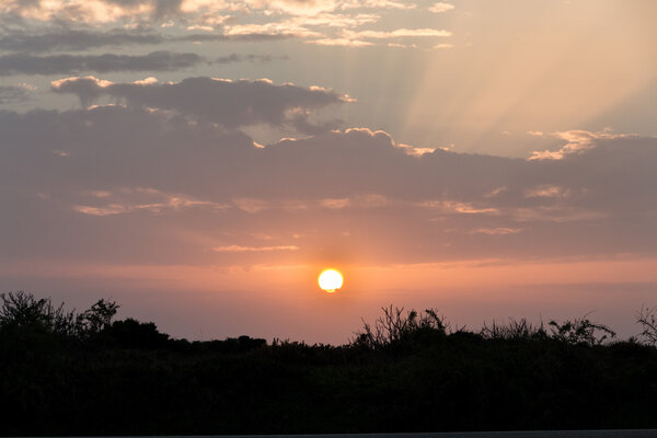 Sunset with clouds, light rays at Lagos, Algarve, Portugal