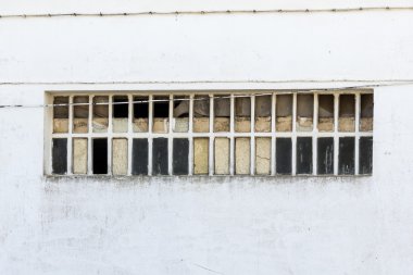 Beyaz bir duvar üzerinde kırık pencere