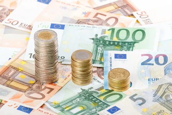 Euro coins stacked on euro banknotes background. — Stock Photo, Image