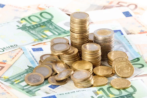 Euro coins stacked on euro banknotes background. — Stock Photo, Image