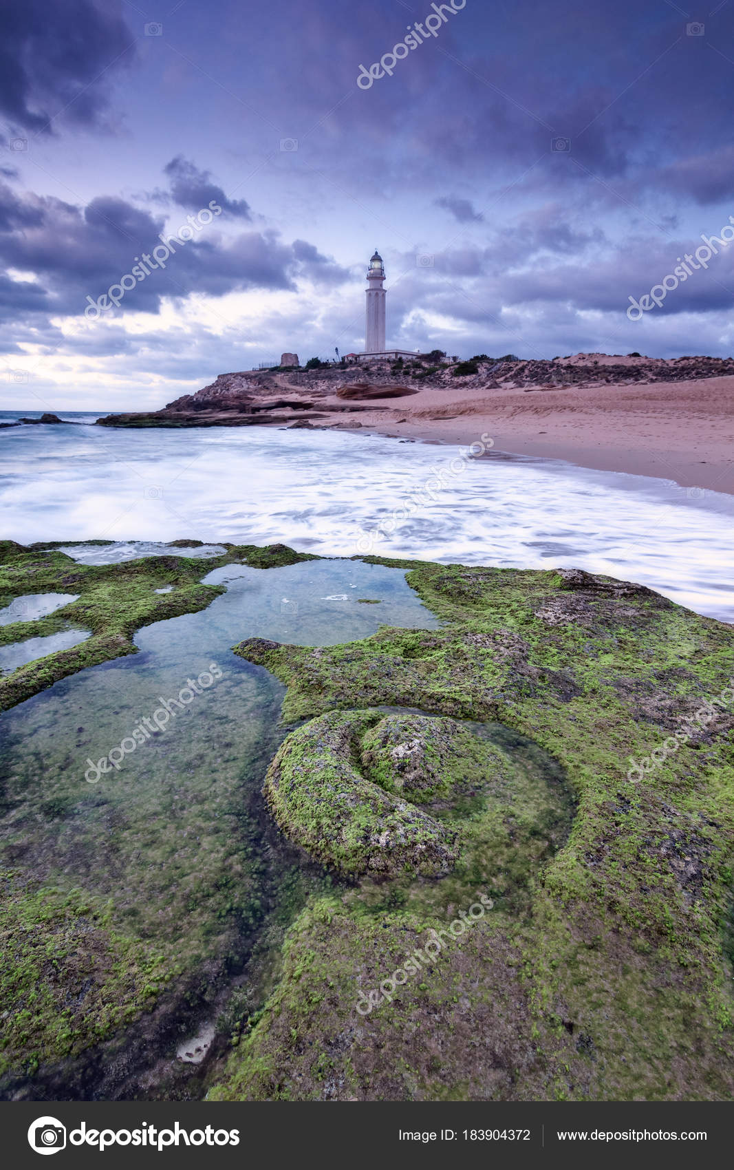 Sunset at Trafalgar beach, nearby lighthouse. — Stock Photo © ajcabeza