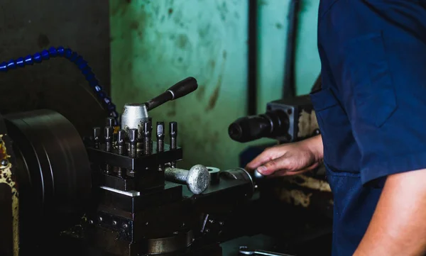 worker use lathe  machine to product in workshop