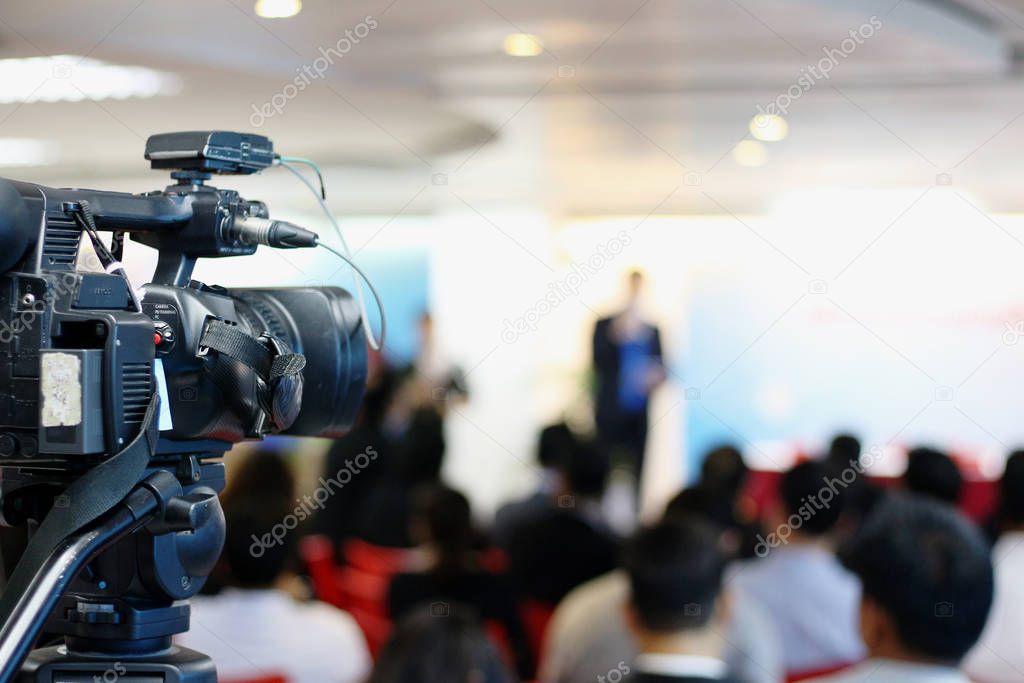 The media is recording video during the press conference. 