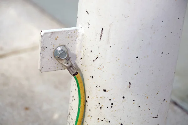 Electrical ground wires connected to a metal junction plate.