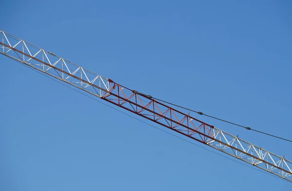 Abstrakt bild, en del av arm maskiner konstruktion kran med blå himmel bakgrund — Stockfoto