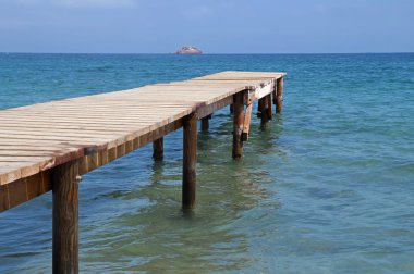 Mavi gökyüzünün altında platform İskelesi ahşap deniz yanında .