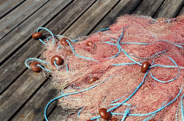 A fából készült móló narancssárga kötél halászháló . — Stock Fotó
