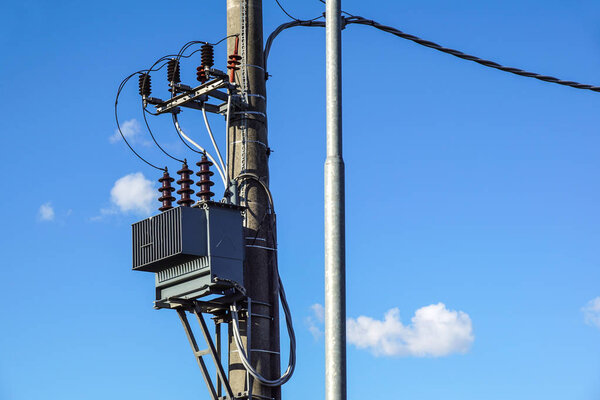High voltage electrical transformer high on concrete poles