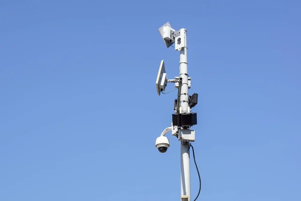 High tech overhead security camera with a blue sky