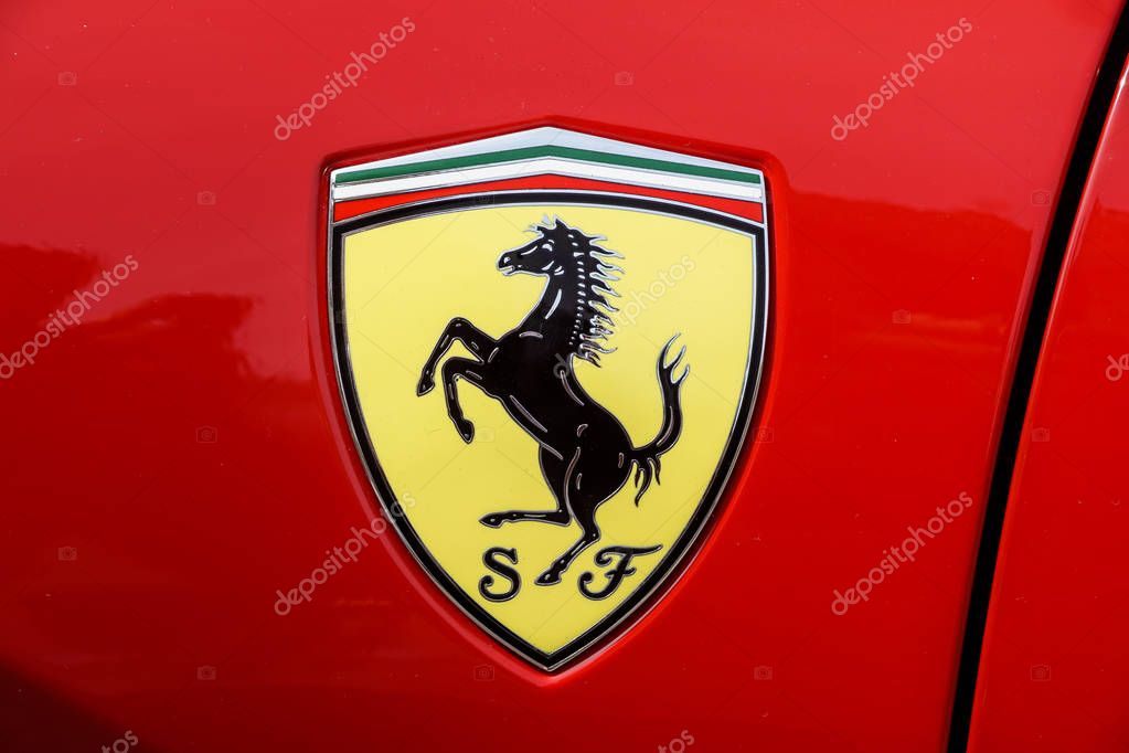 TURIN, ITALY - JUNE 10, 2017: Classic Ferrari logo on a red car body .